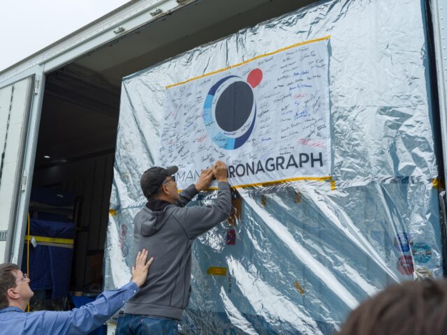 Coronagraph Team Signs Flag Farewell